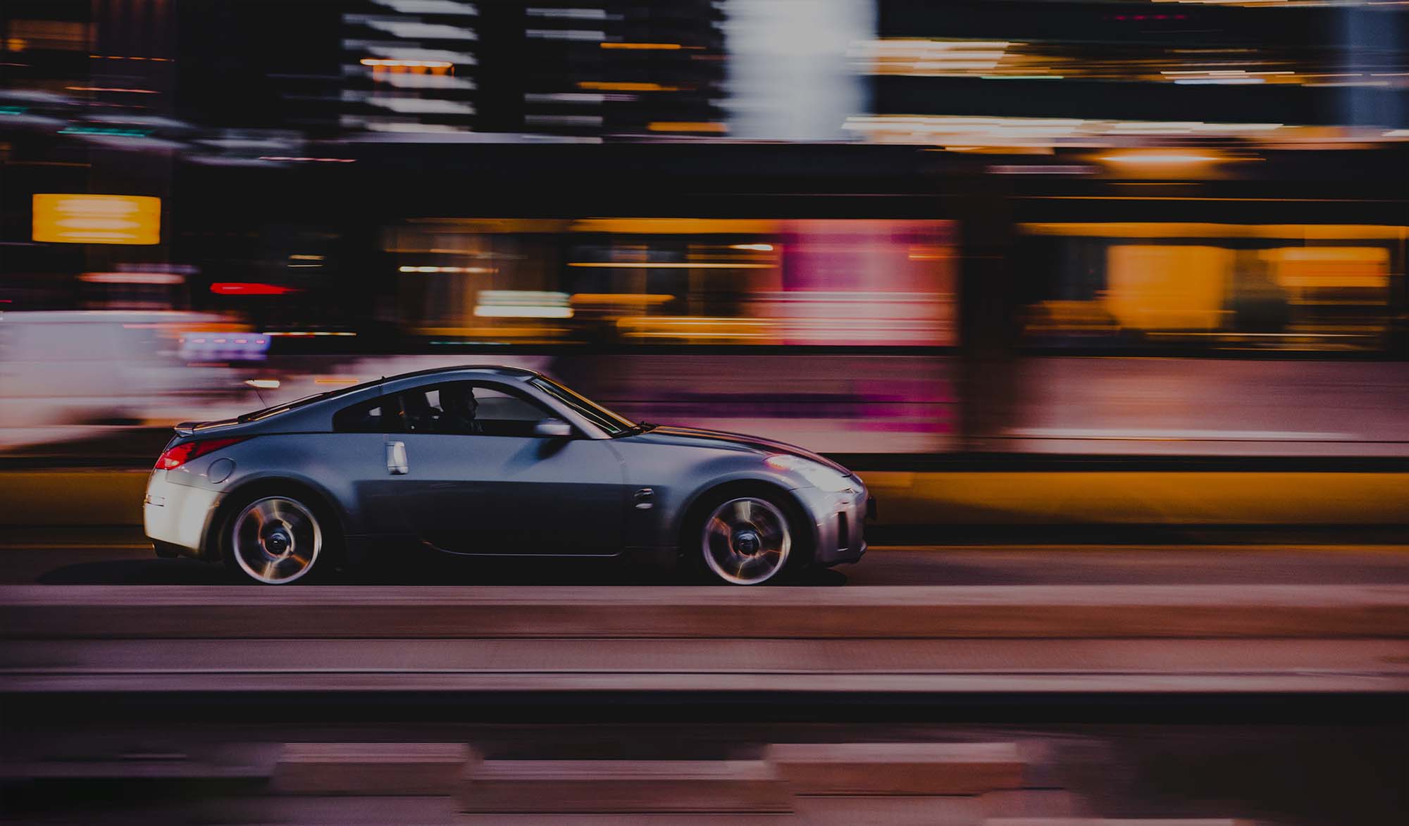Fast car driving in the city at night with motion blur